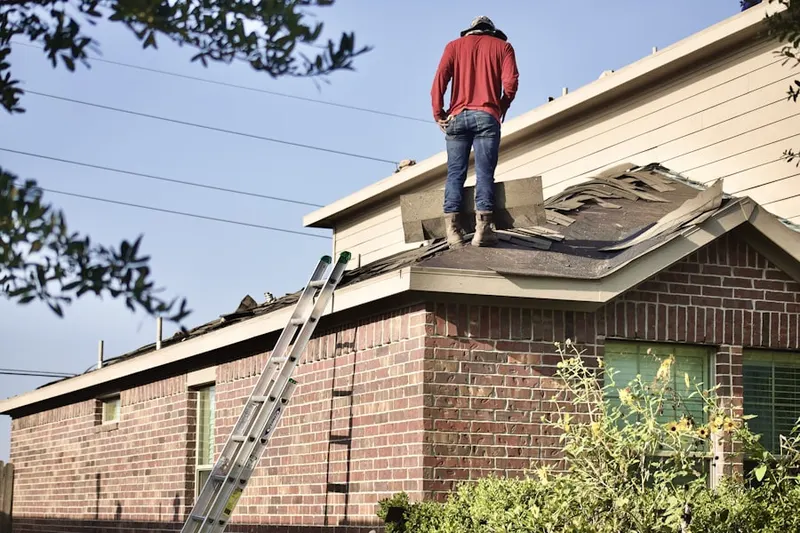Professional roofer working on a residential roof in New Hartford